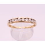A 10 K gold diamond channel set ring. Ring size U/V. 2.2 grammes total weight.