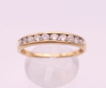 A 10 K gold diamond channel set ring. Ring size U/V. 2.2 grammes total weight.