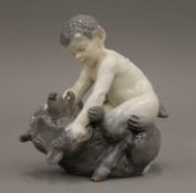 A Royal Copenhagen model of a fawn fighting a bear. 14.5 cm high.