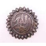 An unmarked silver filigree turban brooch. 4.5 cm diameter.