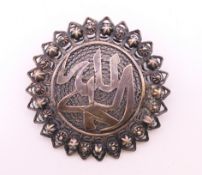 An unmarked silver filigree turban brooch. 4.5 cm diameter.