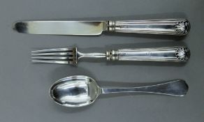 A silver knife, fork and spoon in a case.