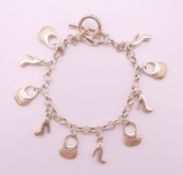 A silver charm bracelet. 18.5 cm long.