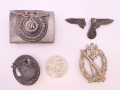 A quantity of German military buckles, badges, etc.