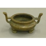 A Chinese two handle bronze censer. 17 cm wide.
