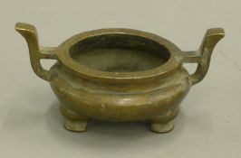 A Chinese two handle bronze censer. 17 cm wide.