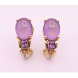 A pair of gold amethyst and diamond earrings. 1.8 cm high.