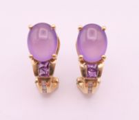 A pair of gold amethyst and diamond earrings. 1.8 cm high.