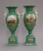 A pair of green porcelain vases decorated with hunting scenes. 38 cm high.