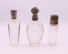Three French silver topped scent bottles. Tallest 9.5 cm high.