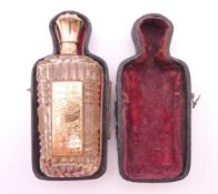 A French 18 ct gold topped scent bottle, cased. 9 cm high.