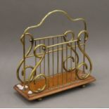 A brass lyre end magazine rack. 36 cm wide.