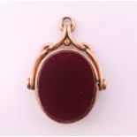A 9 ct gold bloodstone and carnelian swivel fob. 2.75 cm high.