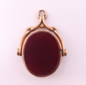 A 9 ct gold bloodstone and carnelian swivel fob. 2.75 cm high.