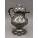 A large 19th century pewter jug. 38 cm high.