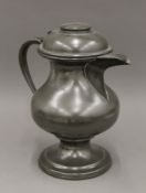 A large 19th century pewter jug. 38 cm high.