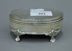 A small silver trinket box. 10 cm wide.