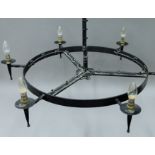 A circular black painted metal chandelier. Approximately 90 cm diameter.