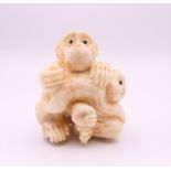 A carved bone netsuke formed as monkeys. 4 cm high.