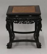A 19th century Chinese carved hardwood urn stand. 46 cm high.