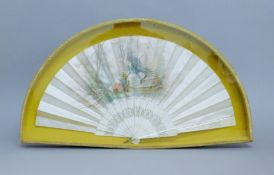 A Victorian silk fan with bone guards, housed in a case. 61 cm wide overall.