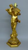 A gilt cherub lamp. 68 cm high.
