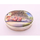 A silver pill box depicting racing cars. 3.5 cm wide.