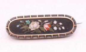 A silver framed pietra dura brooch. 5 cm wide.