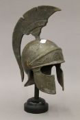 A heavy cast bronze sculpture of a Greek or Spartan helmet with traditional Greek motifs on an