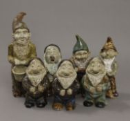 Seven glazed pottery gnomes. The largest 28 cm high.