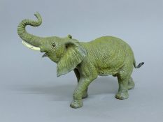 A cold painted bronze model of an elephant. 35 cm long.