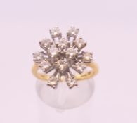 An 18 ct gold diamond spray ring. Ring size O. 5.4 grammes total weight.