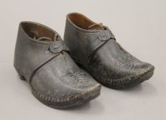A pair of antique studded leather child's shoes. 15.5 cm long.