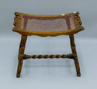 An early 20th century stool with barley twist stretcher. 53.5 cm wide.