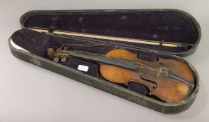 A cased violin, labelled Nicola Amati. The violin 59 cm long.