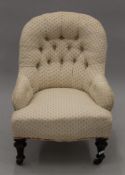 A cream upholstered button back Victoria nursing chair. 56 cm wide.
