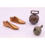 A miniature pair of bronze shoe lasts and two bells. The former 6.5 cm long.