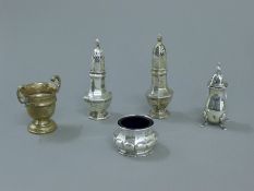 Four silver cruets and a small silver trophy. The latter 6 cm high. 125.7 grammes.