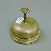 A silver plated counter bell. 10 cm high.