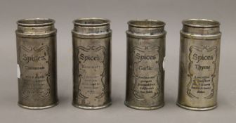 Four metal spice pots. Each 10 cm high.