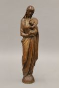 A carved wooden figure of The Madonna and Child. 26 cm high.