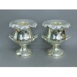 A pair of silver plated wine coolers. 32 cm high.