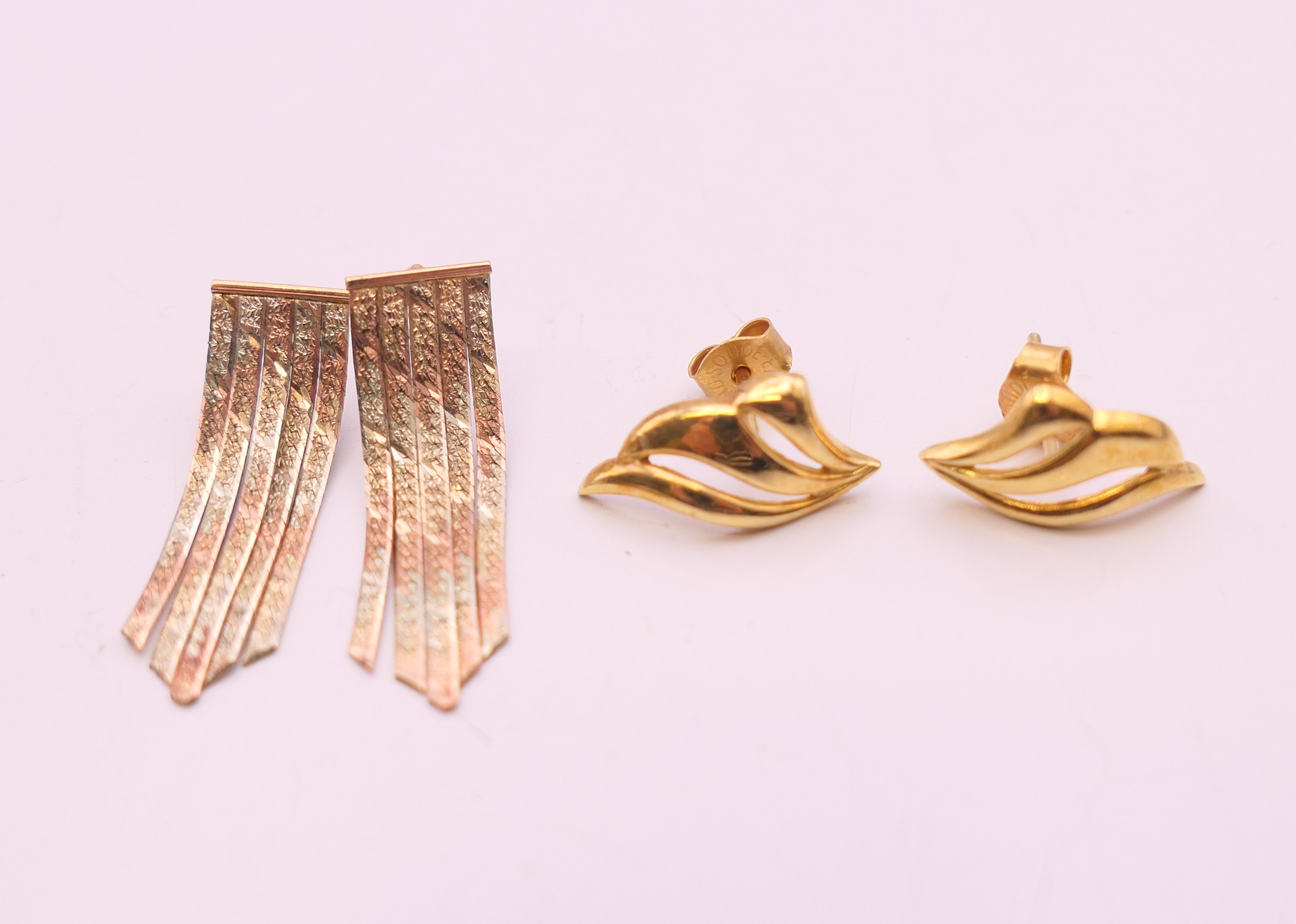 A pair of 9 ct tri colour gold earrings and another pair. The former 2.5 cm high.