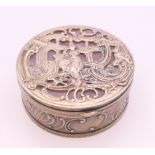 A Continental unmarked silver and rose quartz box. 7 cm diameter.