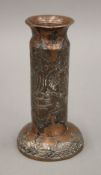 An Islamic copper and silver candlestick. 12 cm high.