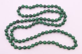 A string of malachite beads. Approximately 88 cm long.