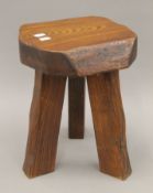 A rustic oak stool, the underside with applied label inscribed 'Wanderwood'. 34.5 cm high.