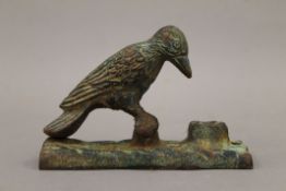 A cast iron woodpecker form door knocker. 15 cm high.