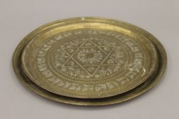 Two Eastern brass trays. The largest 48 cm diameter.