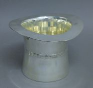 A silver plated top hat wine cooler. 17 cm high.